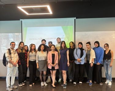 Aylin Özdemir speaking to university students during a guest lecture on payroll practices and employee rights, as part of an industry-academia collaboration event at the Business Administration Department.